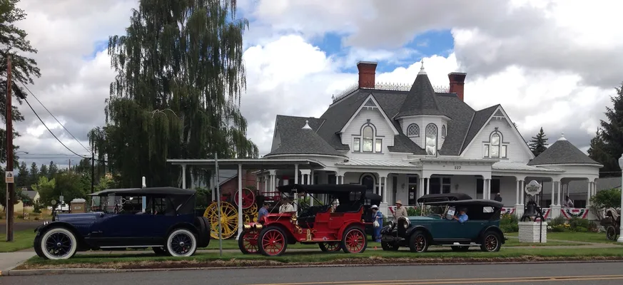 Antique cars parked in front of the museum